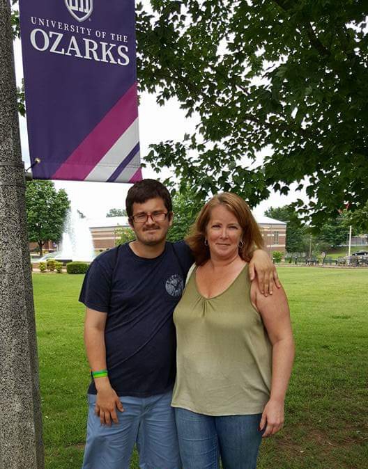 Picture of Stephanie and Matthew under a University of the Ozarks flag